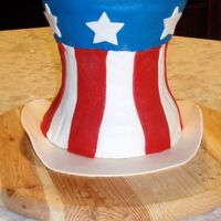 Uncle Sam's Hat Three layers of cakes. Chocolate and confetti cakes. Filling is a light and fluffy cheesecake. Iced in buttercream and covered with fondant...