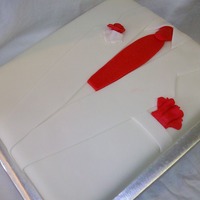 White Tuxedo Groom's Cake White cake covered in vanilla fondant with red fondant accents. Groom loves vanilla!