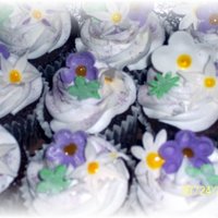 Cupcakes made to match a wedding cake I did. Flowers are gumpaste. I let my friends daughter (7yrs) help me on the flowers! ( cake was for a good...