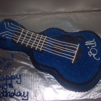 Black And Blue Guitar guitar made from the wilton shaped pan. frosted in buttercream