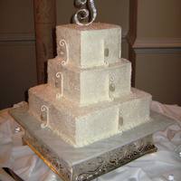 Bling! 3 tier, buttercream frosted cake, covered in sugar crystals. Gumpaste swirls andcandy diamonds painted with edible glitter, and hung from a...