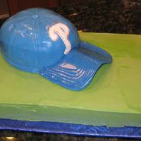 Phillies Baseball Hat Groom's Cake Phillies baseball hat on top of green field sheet for Groom