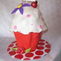 Oversized Cupcake cake for my neighbors daughter. Made from 3 6" cakes covered with fondant.