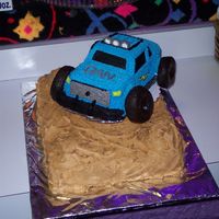 Monster Truck Birthday Cake The idea is from an old Wilton yearbook. Made with the 3-D cruiser pan, with a 11x14 base, with mini wonder pan hills. My godson picked it...