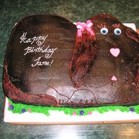 Janie puppy carved from 12 X18" chocolate cake. covered in bc and airbrushed brown- gumpaste boe and mmf eyes and nose