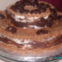 Chocolate Fish Groom's Cake 2 tier flourless chocolate tortes coated with a ganache, and then wrapped with marbled chocolate collars. Decorated with dark chocolate...