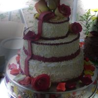 Scrolls And Ribbon And Flower Petals This was a fun cake for a very fun bride. Outdoor wedding, very humid, but the buttercream held up just fine. Fondant ribbon draping cake,...