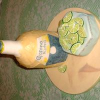 Corona With Lime Bottle is bc with fondant bottle neck and lable. The limes are all made of fondant, sitting on a small cake covered with mmf.