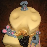 "cheese Cake" covered in fondant, fondant mice, and grapes. i used a teaspoon to scoop out "holes" before covering. for my sister in laws wine...