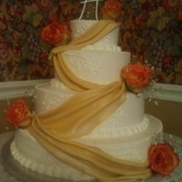 Fall Wedding four tier, lemon, chocolate, and white cakes...buttercream iced, fondant drapes