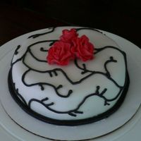 Practice Before Course 3 Final Marshmallow fondant topped with Wilton red fondant roses, chocolate MMF rope, chocolate buttercream vines. I really need to practice my...