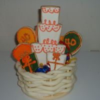 40Th Cookie Basket NFSC with royal icing. I used the melted chocolate method to put cookies on sticks. I made the basket from chocolate "clay."...
