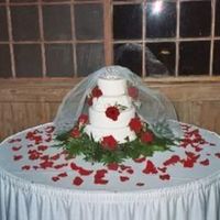 Red Rose Wedding Cake Here is a wedding I did for a friend's wedding in Oct I used fresh roses, made some scroll work, put a crown and a vail on top of the...
