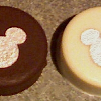 Mickey Mouse Oreos Chocolate and vanilla covered Oreos with silver pearl dust stenciled Mickey ears. I did 110 each (total 220 cookies) as favors for a sweet...