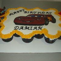 Cars Cupcake Cake This is my first cupcake cake. I made this with 24 chocolate cupcakes. I drew teh lightening mcqueen using a projector, then filled it in...