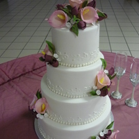 Litonya Almond Pound Cake with buttercream filling and Fondx. Royal piping with pearls and silver dragees. GP flowers.