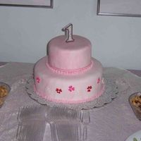 Eleanor's First Birthday Cake White cake Cream Filling covered in pink marbled MMF and candy accent