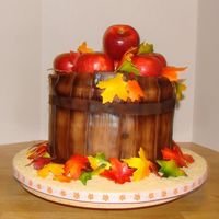 Apple Basket Cake White cake with buttercream icing. The basket is made from fondant. The leaves are made from gumpaste.