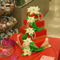 Poinsettias & Pearls Cake from the AC Moore Holiday Fair. 6, 8, 10, & 12 inch squares, red fondant with old gold stripes and gum paste poinsettias, sty with...
