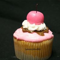Sundae Cupcake butter yellow cupcake w/ buttercream frosting in rose pink w/ melted chocolate, white buttercream swirl & Satin Ice cherry on top.