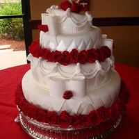 Topsy Turvy Wedding Cake Decorated With Hearts And Red Roses Smaller version of Topsy Turvy Wedding Cake decorated all with handpainted hearts, bows, tassels, red roses, and gumpaste hearts as a...