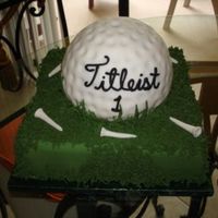 Golf Ball In Green All fondant golfball with sugar tees and royal icing grass. I made a separate flag but it does not appear on this picture. That was made...