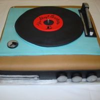 Replica Of A 1970's Record Player This cake is a replica of a 1970's record player. Everything on this cake is fondant. Had a lot of fun working on it!