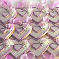 Valentine's Cookies Glace icing and buttercream roses that were brushed with petal dust when dry for some color.