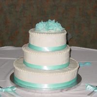 Very First Wedding Cake!! This was a simple yellow cake. The bride wanted bavarian creme and raspberry filling in all layers with vanilla-almond buttercream icing....