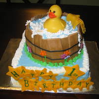Ducky In Washtub butter cream frosting, fondant boards, flowers, stars, the duck was pre-made with milk I think the brand wad quacks.