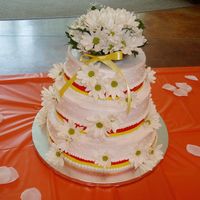 Daisy The bride picked out the ribbon to match her color theme. She wanted fresh daisy's. I also made the cake topper. Very fun for my first...