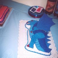 Dragon Cake I made this for my son out of a dinosaur cake pan and used color flow for the wing and scales