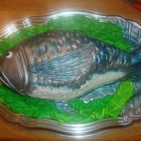 Colette's Fish Cake My goodness!! This cake was just a mess,lol. It was my first time carving a cake and I feel like I wasted so much of it. It is dark...