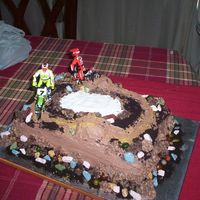 Dirt Bike Cake made for grandsons 11th birthday where the white part is i filled it in with blue for water [ camera not working right now or would replace...