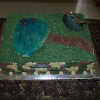 Groom's Hunting Cake Hunter behind a blind, ducks in the pond and camouflage on the sides