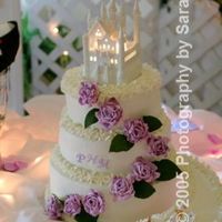 Wedding Cake For Michille And Phillip 3 different flavors, white chocolate icing-had to use photographers pictures-had to set up at site so couldn't use own camera!