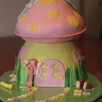 Fairy's House bday cake for my little daughter.the pink fairy and yellow caterpillar made by my 5y old daughter :)