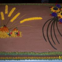 Thanksgiving_Cake_001.jpg This is a 1/2 sheet made from scratch yellow cake with chocolate buttercream icing. The decorations are buttercream and the flowers are...