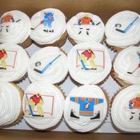 Hockey Cupcakes Jumbo cupcakes with buttercream icing. I used rolled white fondant and hockey stickers to top the cupcakes!