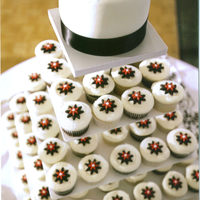 My First Wedding Cake! Wedding cupcakes and cake for a friends daughter's wedding. 120 cupcakes with fondant daisy toppers, small fondant covered WASC cake...