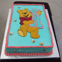 Winnie The Pooh 1St Birthday Freehand Pooh bear, piped in stars. Bee's are made out of chocolate