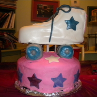 Roller Skate Cake Carved chocolate cake on wooden stand. RKT wheels all covered in MMF. First truly carved cake..ugh.