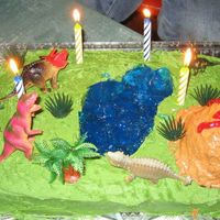 Top Of The Food Chain Dinosaur themed cake complete with blue Jello 'lake' and erupting volcano. Used plastic dinos on the cake so each child could...
