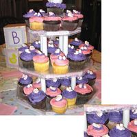 Its A Girl Cupcake Tower Chocolate and vanilla cupcakes on a cakeboard tower iced with buttercream icing and topped with sugar baby heads and booties. "Its a...