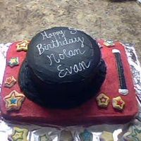 Att00092.jpg This was my very first cake. It was for my cousin Nolan Evan. He was turning 5. It isa magic top hat sitting on a red table. It is all cake...