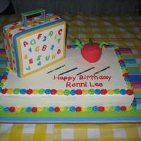 Off To School Cake This was for my cousin who was starting school shortly after her birthday. Lunchbox is cake covered in fondant, as well as the apple.