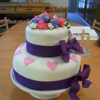 Two Tier Valentine Cake I am so new at this! The buttercream under the fondant on the top tier was not thick enough, so there were some bumps. Can anyone tell me...