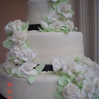 J&n Wedding Cake This is a WASC cake with White Chocolate Raspberry coffee creamer flavoring and a white chocolate fondant. The flowers are gumpaste.
