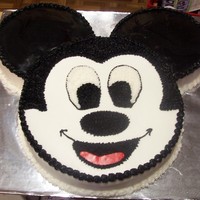 Mickey Mouse 12" White cake for head, 8" Choc & Strawberry cake for the ears. Fondant for the ears and mouth. Did this for my own birthday...