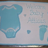Baby Shower Cake White and Choc cake with fondant onzie and baby feet.